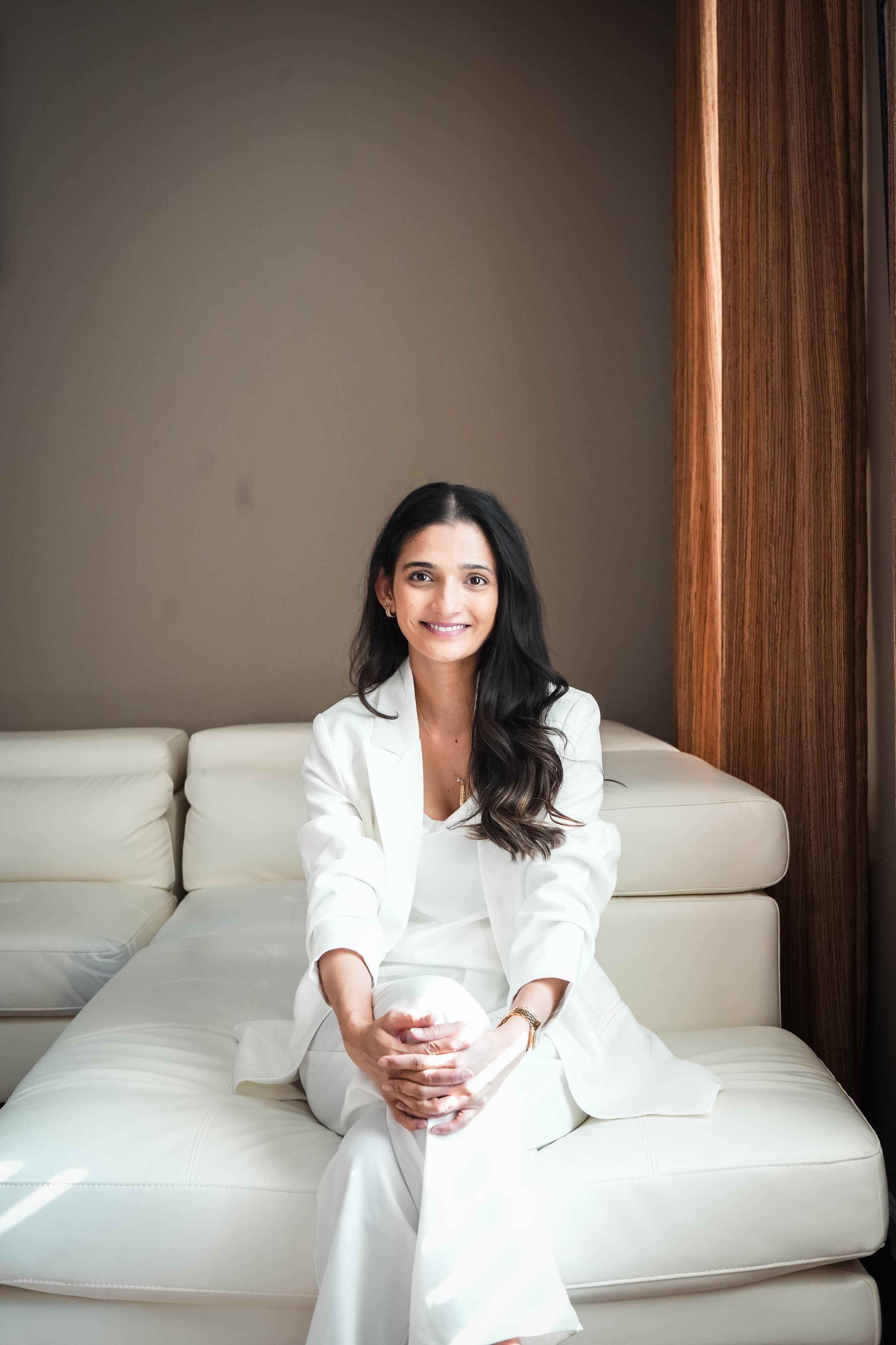 Kajal smiling in a soft editorial portrait